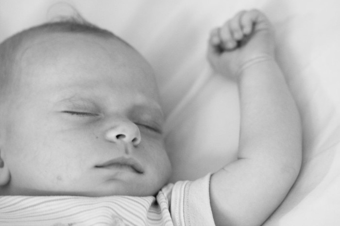1024px-Sleeping_baby_with_arm_extended