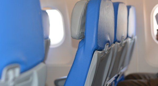 The Confusing Etiquette Of Flying In A Middle Seat And Who Really Should Get The Armrest