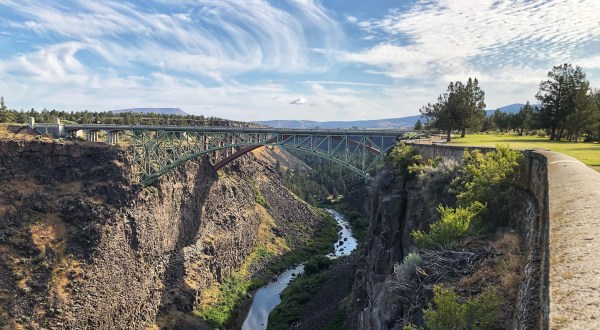 Peer Over The Bridge Into The Deep Chasm Of The Crooked River Gorge In Oregon