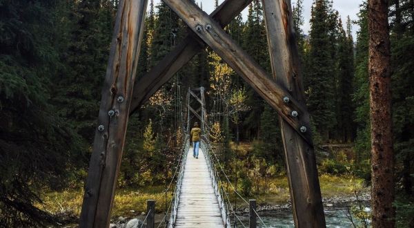 Walk Across A Suspension Bridge On Triple Lakes Trail In Alaska