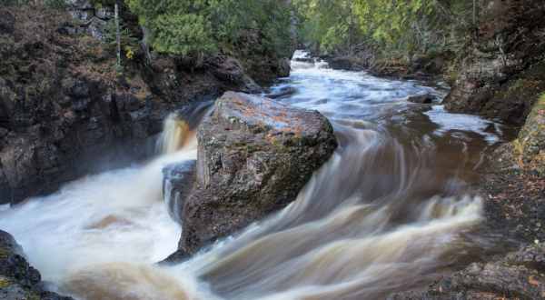 Watch A Waterfall Tumble Over A Rocky Gorge At The Breathtaking Cascade River State Park In Minnesota