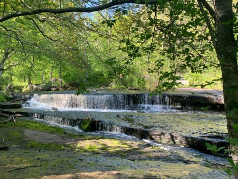 Plan A Visit To Stepstone Falls, Rhode Island's Beautifully Blue Waterfall
