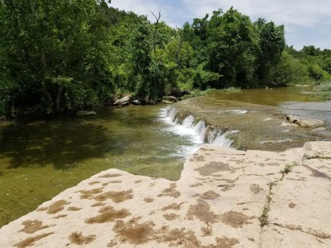 This Easy, 3.8-Mile Trail At Bull Creek Park Leads To One Of Texas' Most Underrated Waterfalls
