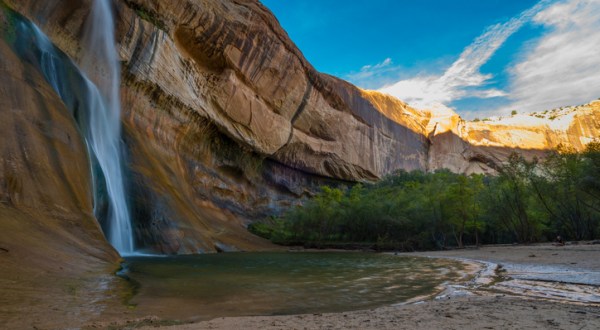 Wade In The Refreshing Waters On The Scenic Beach At Calf Creek Falls In Utah