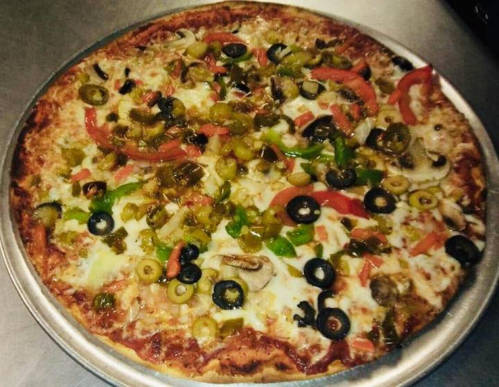 An all veggie pizza with jalepenos and both kinds of olives.