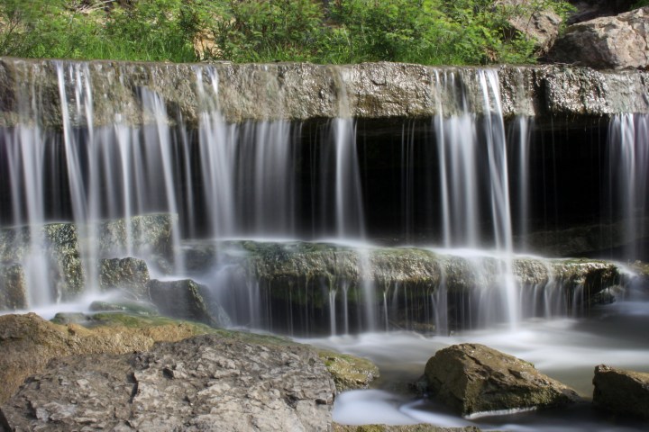 A slow capture of the waterfall's front, with smooth lines of water.