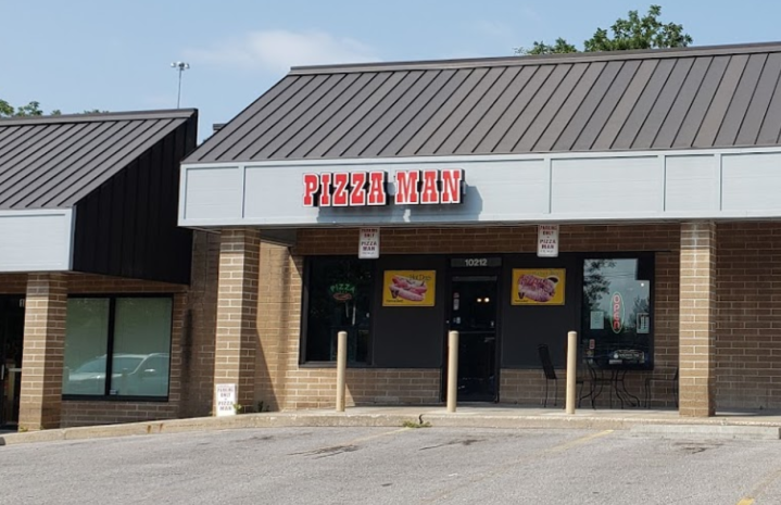 A view of the front of the restaurant, that says Pizza Man in large red letters.