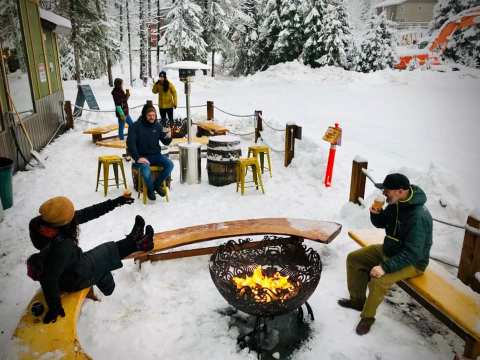 Cozy Up Around The Fire In Girdwood Brewing Company's Beer Garden This Winter In Alaska