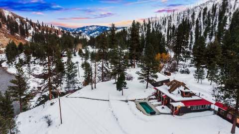 Spend A Night At A Historic Hot Spring Ranch In Idaho While Surrounded By Snow-Capped Pine Trees