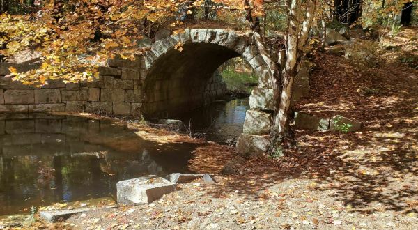 Wander Over An Old Stone Bridge At The Arched Bridge Conservation Area In Massachusetts