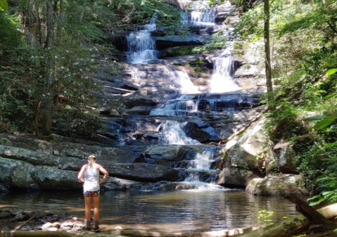 Wade Under A Waterfall Along The Emery Creek Falls Trail In Georgia