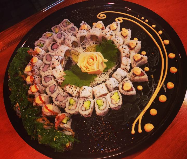 a plate full of sushi arranged in a circle