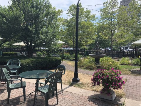 Clara’s On The River In Michigan Has A Gorgeous Patio That Feels Like Dining In A Secret Garden