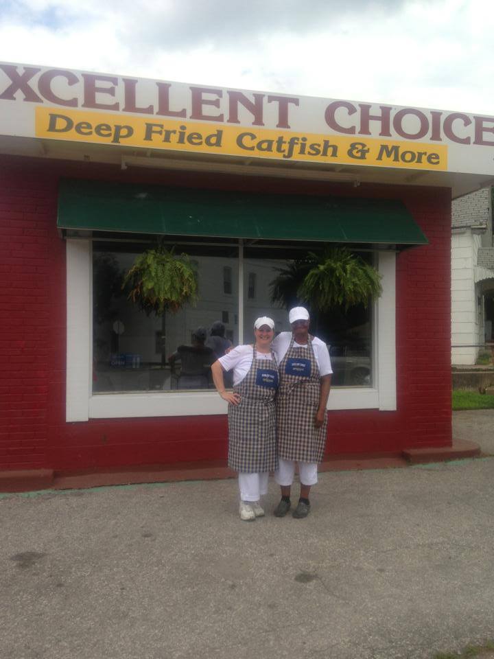Two owners stand in front of Excellent Choice: Fried Catfish and More, a restaurant in Leavenworth, Kansas