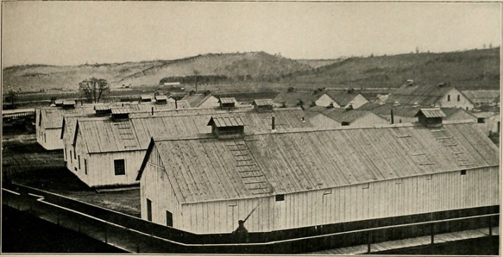 Vintage photo of the barracks at Elmira Civil War Prison Camp in New York, one of the town's most haunted sites.