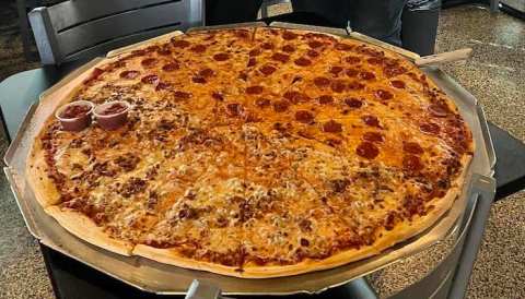 The Pizza At This Delicious Iowa Eatery Is Bigger Than The Table