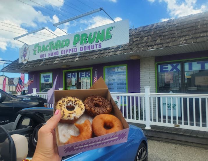 Person holding a box of doughnuts at Fractured Prune on Delaware's Culinary Coast