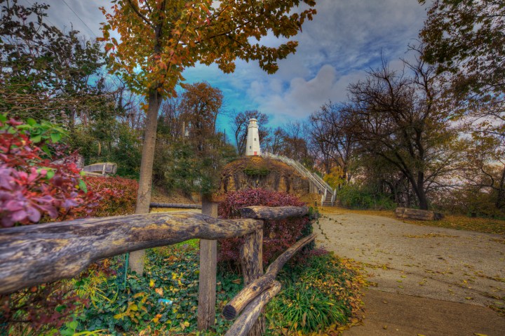 Hannibal Missouri Marion County Photo taken on November 7, 2019 Great River Road Series A beautiful flower garden surrounds this memorial lighthouse which overlooks the mighty Mississippi River. A rustic wooden fence leads the viewer to the distinctive lighthouse. Constructed as a memorial to Hannibal's most famous citizen, Mark Twain on the 100th anniversary of his birth.