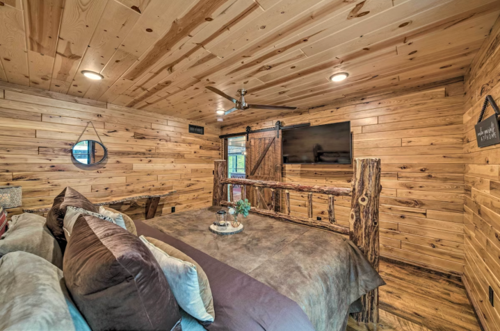 The home has three bedrooms, two on the first floor and one on the second-floor loft. On the main floor is a King-sized bed with impressive woodwork throughout.