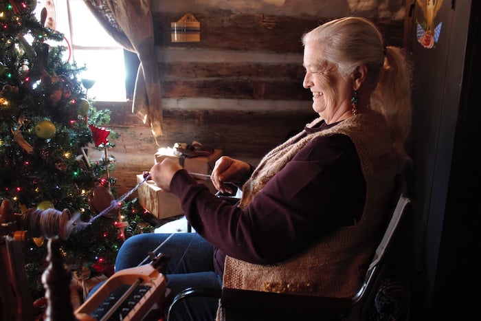 A crafter works happily at LaGrange Historic Site's Christmas in the Country event, which allows guests to experience a pioneer Christmas in Alabama.