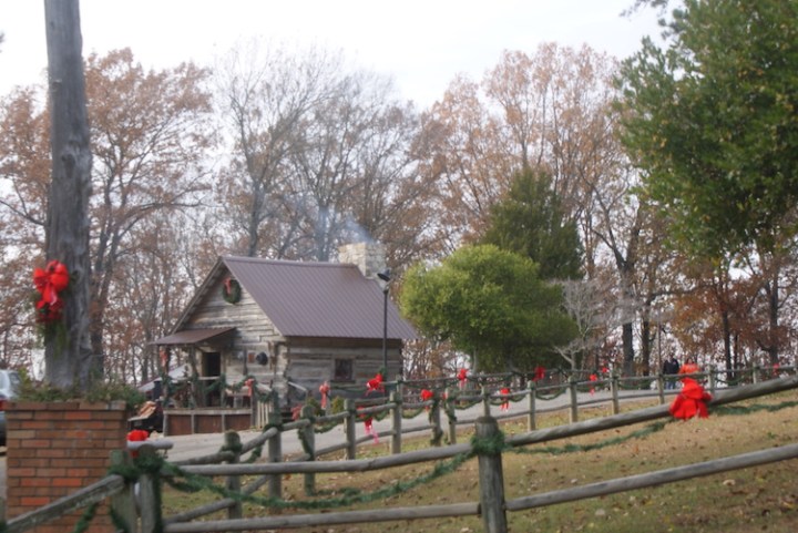 A wide view of a cabin and fencing at LaGrange Historic Site's Christmas in the Country event allows guests to experience a pioneer Christmas in Alabama.
