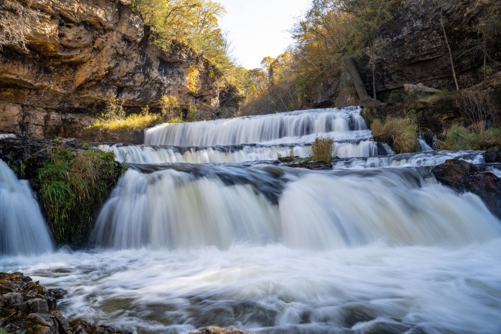 Waterfall at Willow River State Park in Hudson Wisconsin in fall. Daytime long exposure with silky water